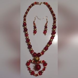 Hand crafted red and gold beaded necklace and earring set.